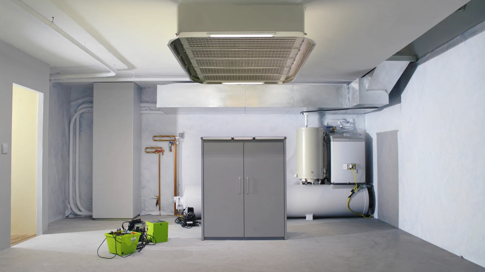 Clean residential mechanical room with water heater, ductwork and piping